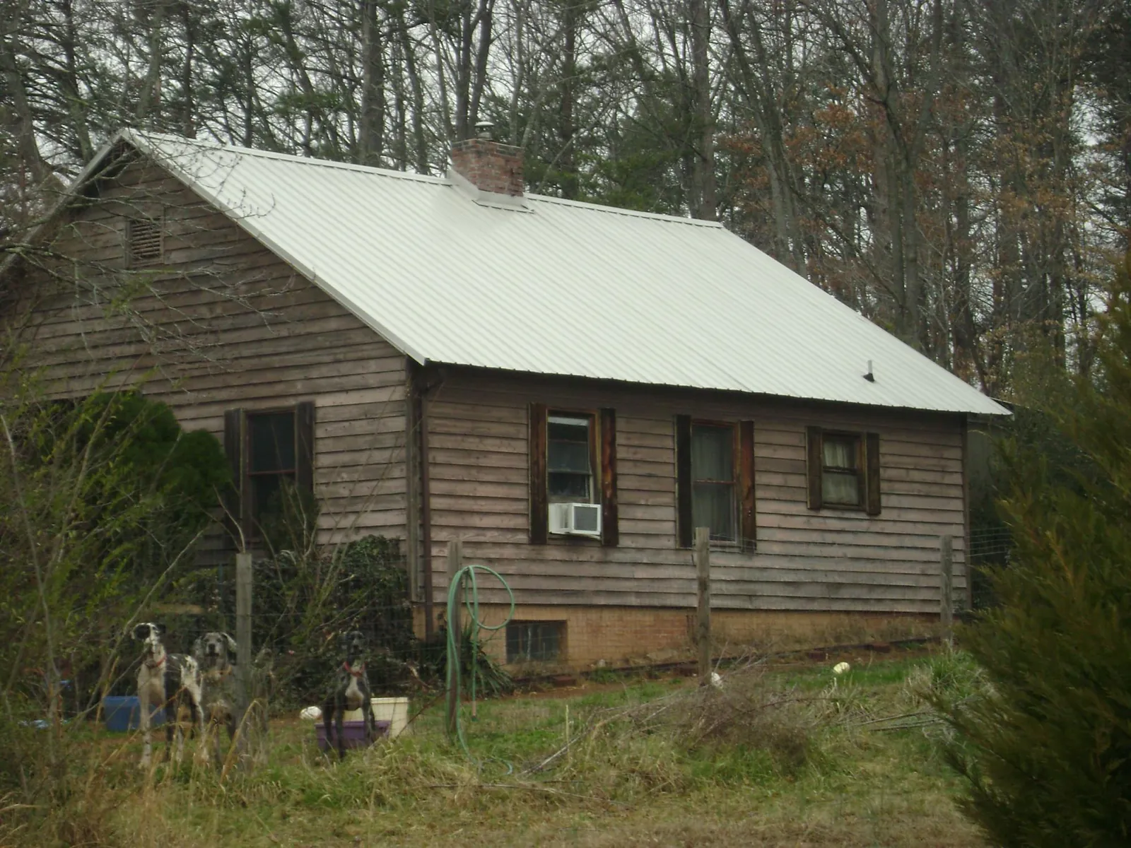 White metal roof on an old wood sided farmhouse, from a Metal Roof Installation job in Gloverville